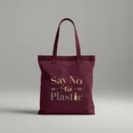 Durable eco-friendly maroon canvas tote bag with a minimalist typographic design in earth tones. The text 'Say No to Plastic' is printed in olive green and soft orange, accented with small leaf and seedling illustrations.