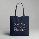 Durable, eco-friendly navy blue canvas tote bag with a minimalist typographic design in earth tones. The text 'Say No to Plastic' is printed in olive green and soft orange, accented with small leaf and seedling illustrations.