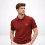 A male model looking to the side, wearing a brick red HL NOVA polo t-shirt with a white logo.