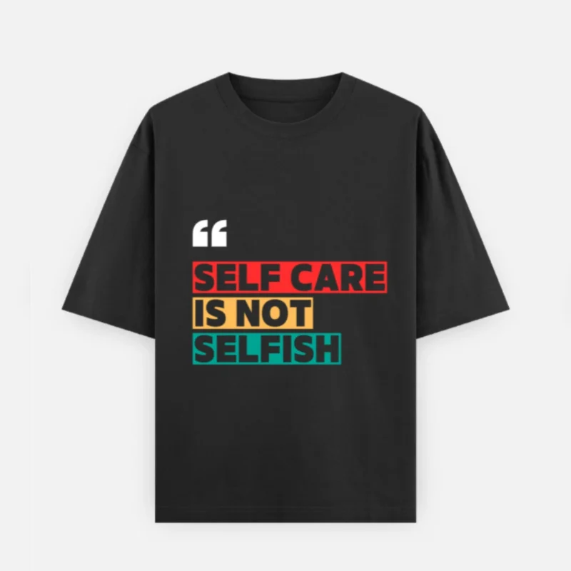 Front view of a premium black unisex oversized heavyweight t-shirt. The chest displays white quotation marks above the bold graphic statement "SELF CARE IS NOT SELFISH", with "SELF CARE" on a red background block, "IS NOT" on a yellow block, and "SELFISH" on a teal block. Features a loose crew neckline and relaxed slouchy sleeves.
