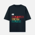 Front view of a deep navy blue unisex oversized t-shirt made of 240 GSM heavyweight cotton. It features white quotation marks and the text "SELF CARE IS NOT SELFISH" highlighted in contrasting red, yellow, and teal block graphics across the chest, designed with dropped shoulders for a relaxed fit.